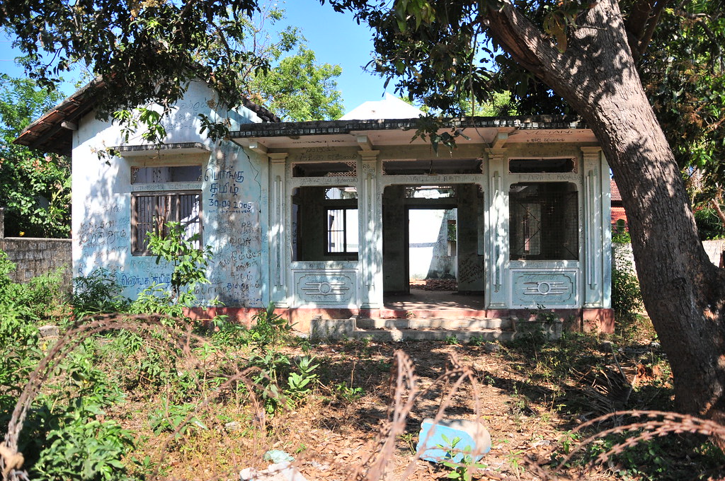 A weathered single-storey building among trees, supplied to the archive as an unverified reference image